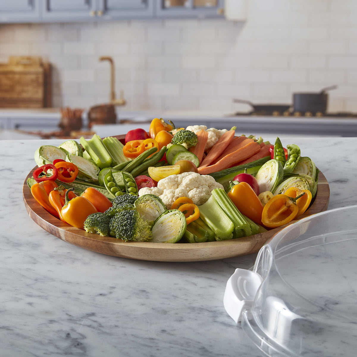 Build-a-Board Acacia Cutting Board 14 inch Round filled with a vibrant fruit assortment on a dark surface