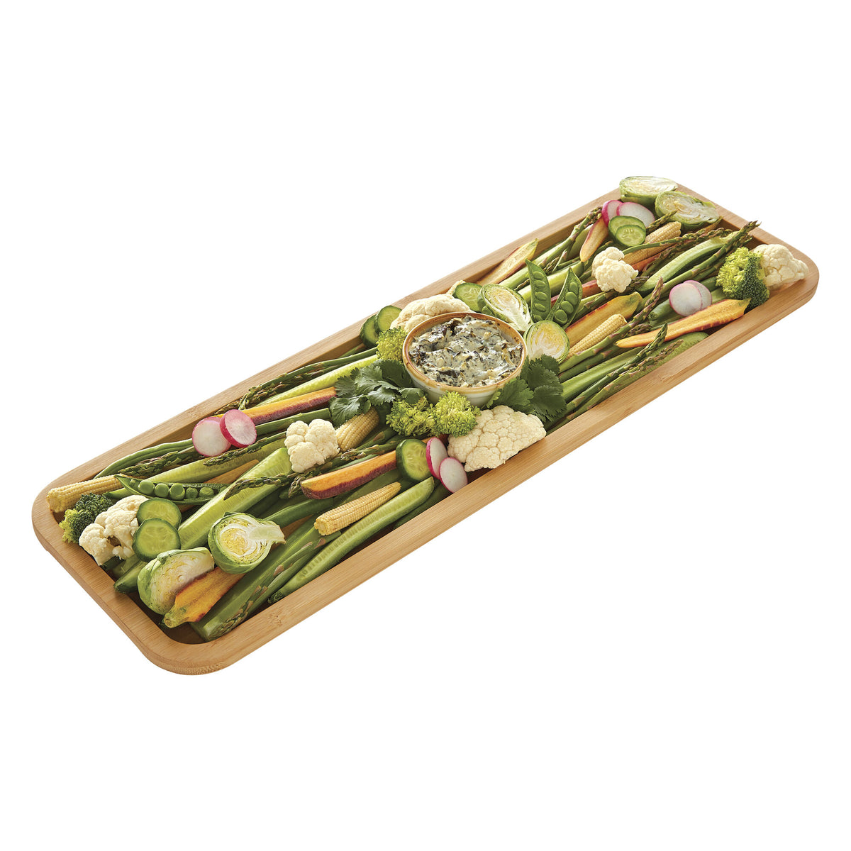 Bamboo cutting board topped with bright vegetables on a white background