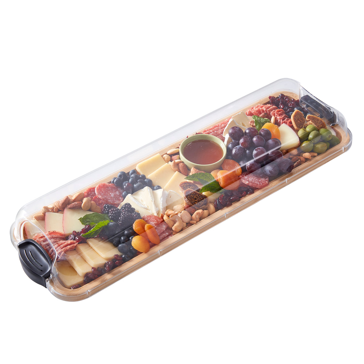 Build-a-Board bamboo cutting board filled with cheeses, grapes, nuts, and fruit under a clear lid