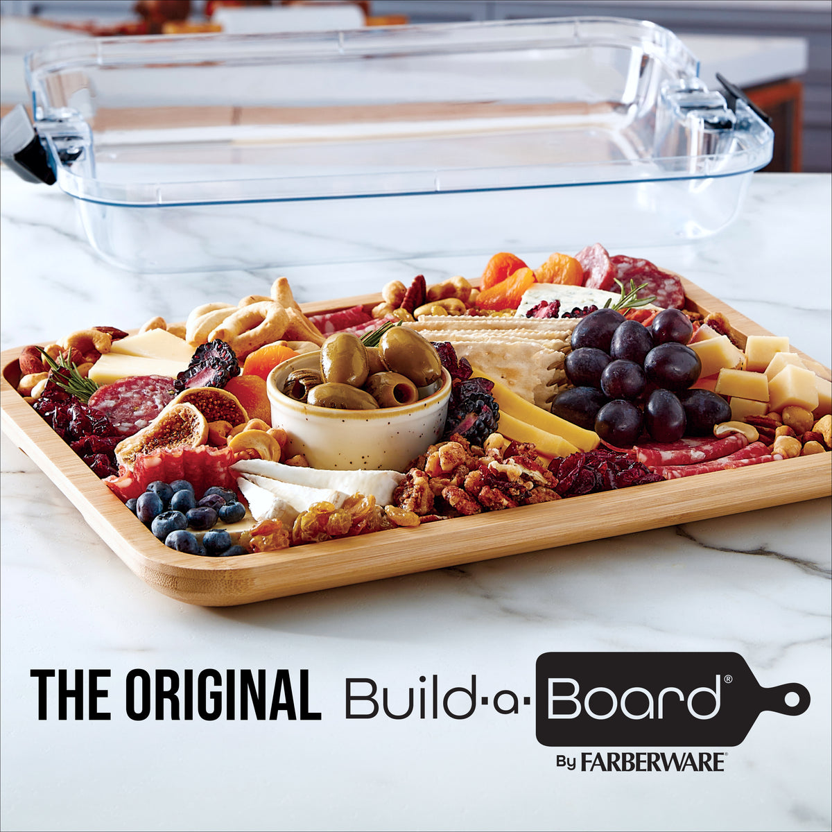 Charcuterie board with cheeses olives grapes and vegetables arranged on a wooden tray
